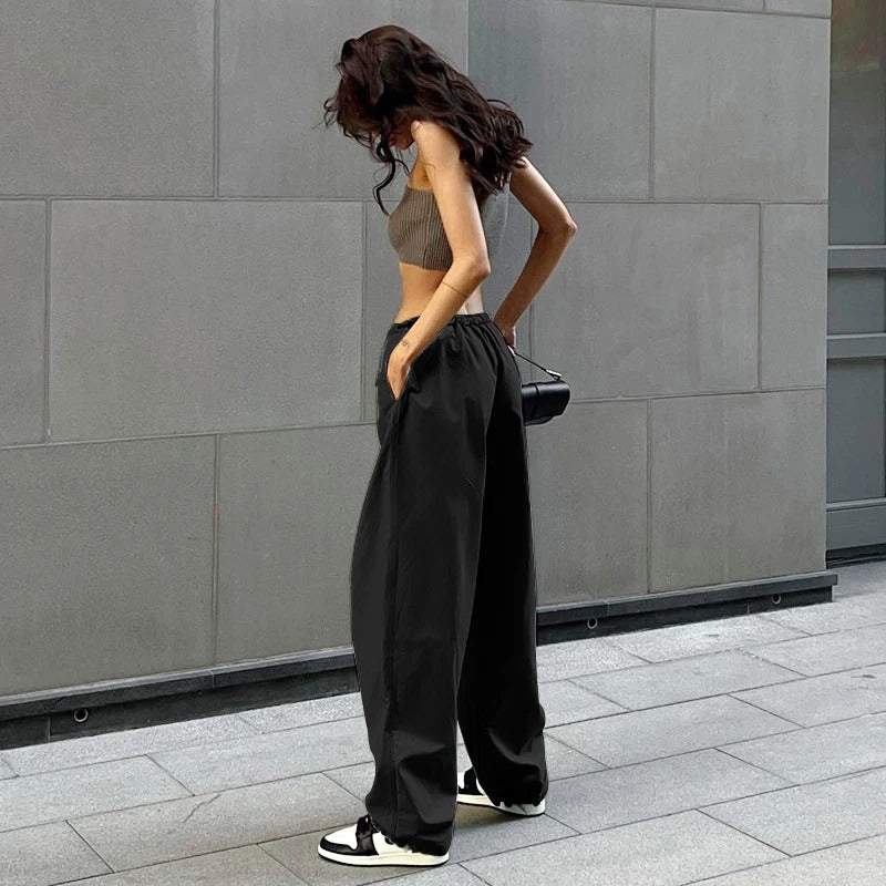 Schwarze Parachute-Hose mit verstellbarem Bund, mehreren Taschen und leichtem Stoff für Freizeit und urbanen Stil